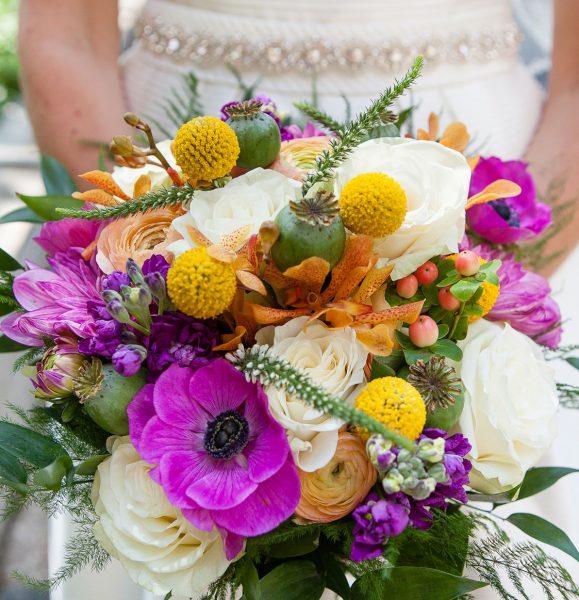 Wedding Photographer takes picture of bride's colorful bouquet