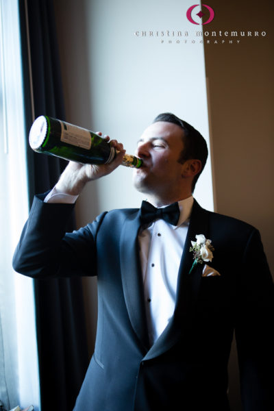 Groom Drinking Champagne Out of the Bottle