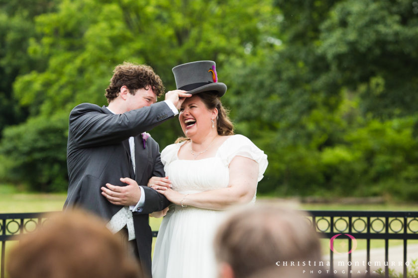 Groom puts his top hat on his bride during their wedding ceremony