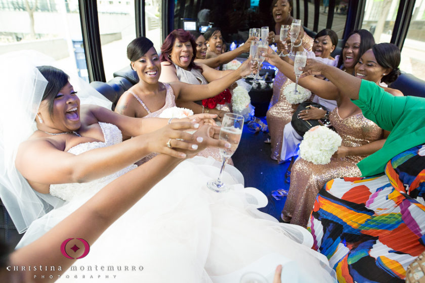 Bride and bridesmaids drinking champagne on the limo party bus