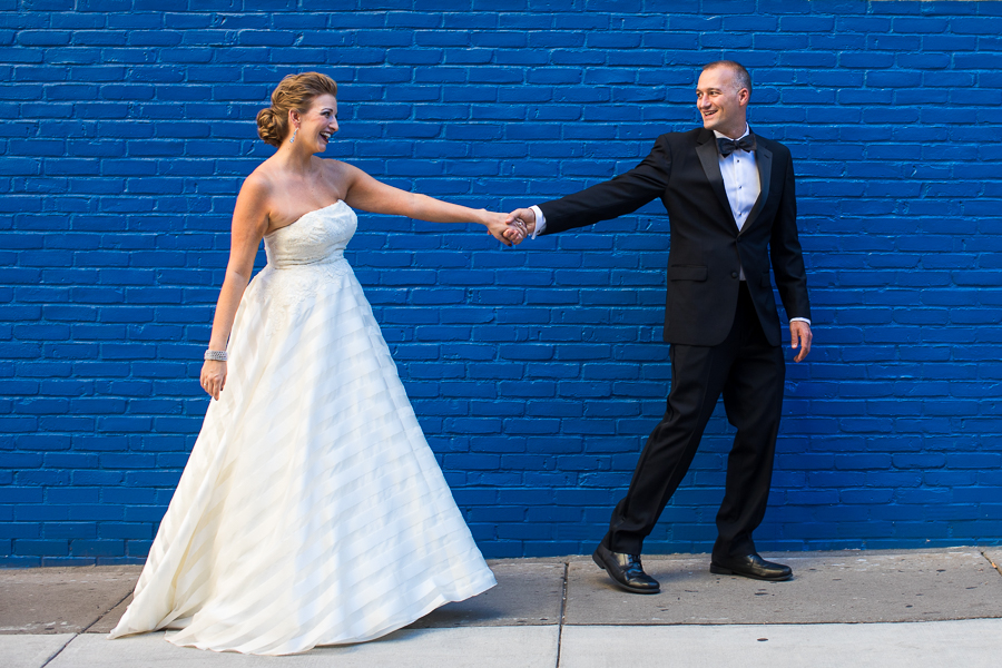Bride and Groom in front of Bright Blue Brick Wall in Downtown Pittsburgh