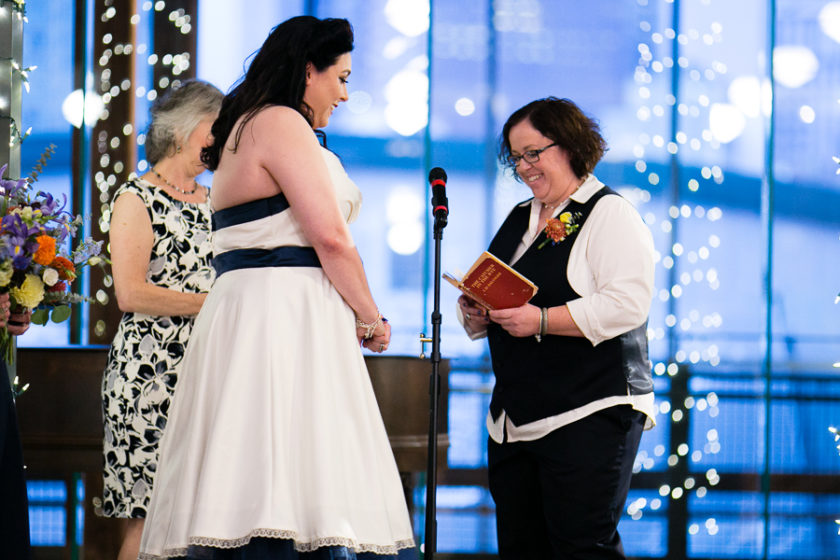 Bride Reading Vows inside Catcher in the Rye Book at Library Wedding