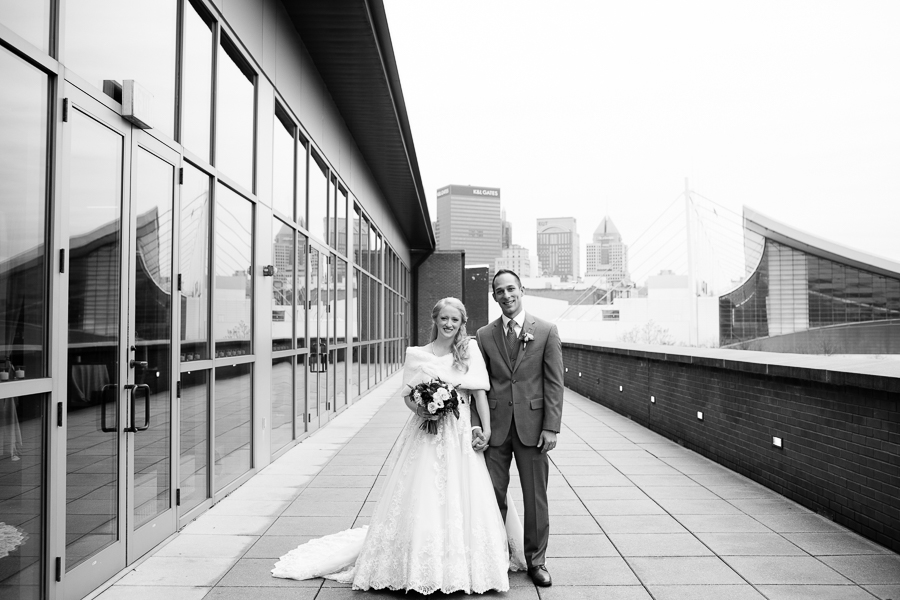 Bride with White Fur Wrap and Groom in Gray Suit on Heinz History Center Balcony