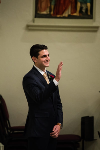 Groom waving to Guests before his wedding ceremony