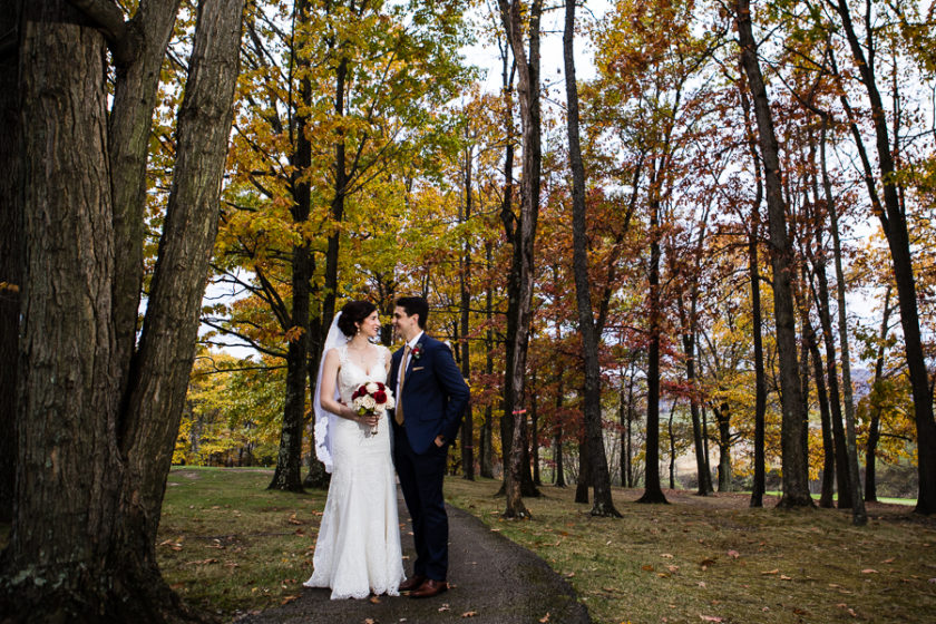 Bride and Groom on Tree Lined Path with Fall Foliage at Lenape Heights Golf Resort