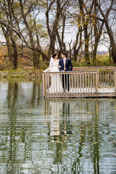 Bride and Groom at Lenape Heights Golf Resort with water and tree reflections, November wedding