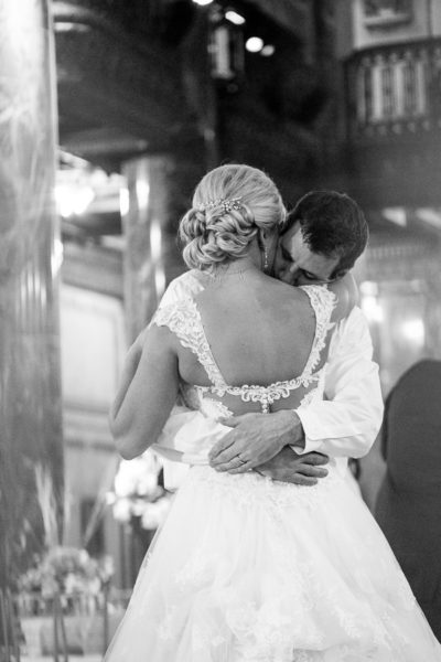 Bride and Groom Hug at the end of their wedding reception at the Carnegie Music Hall Foyer