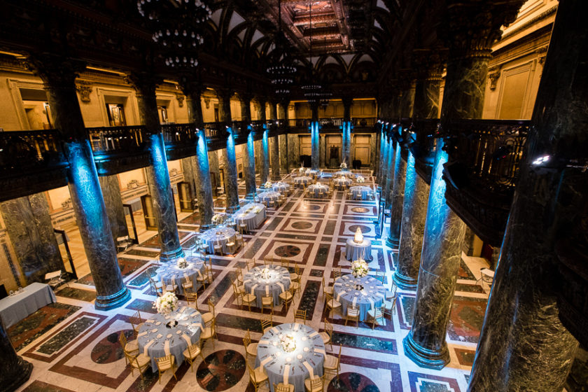 The stunning Carnegie Music Hall Foyer Wedding Reception with Blue Uplighting and Light Blue Linens