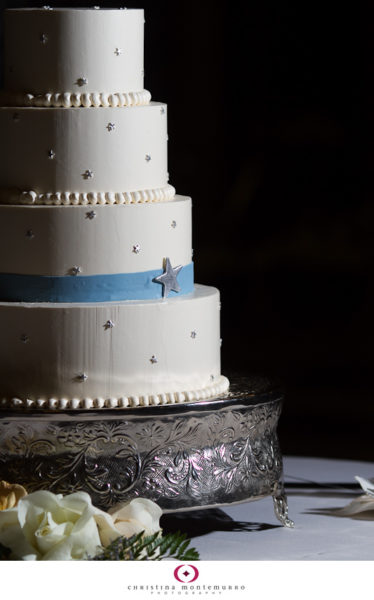 Four Round Tier White Wedding Cake on silver base with silver stars and blue ribbon