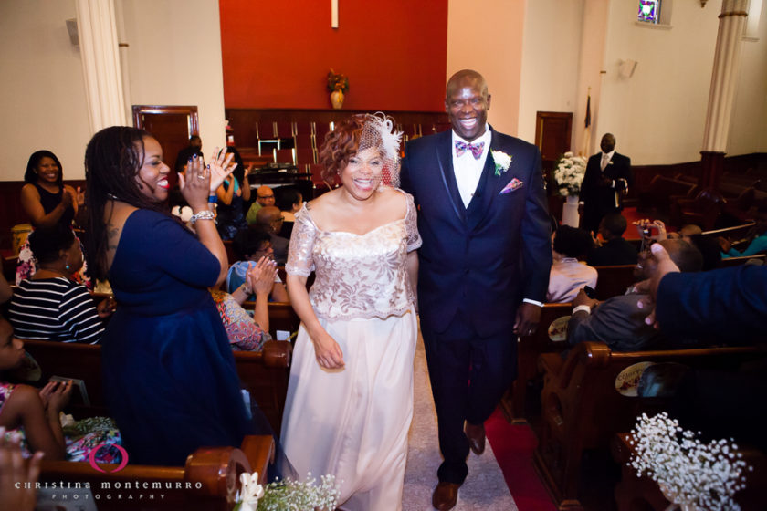 Happy bride and groom walk out of St. Paul Baptist Church Pittsburgh Wedding Photography