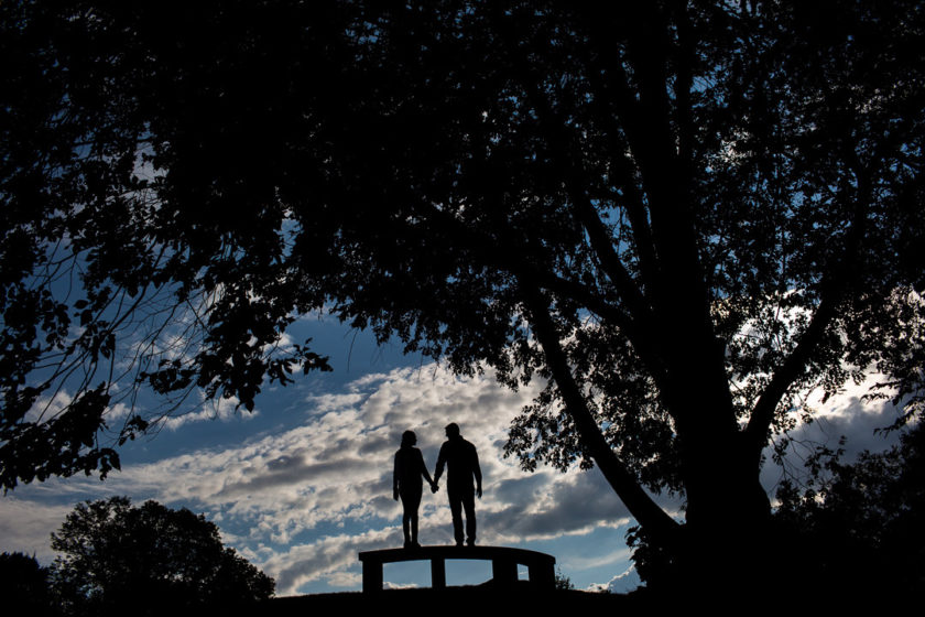 Silhouetted couple on a bench in Mellon Park