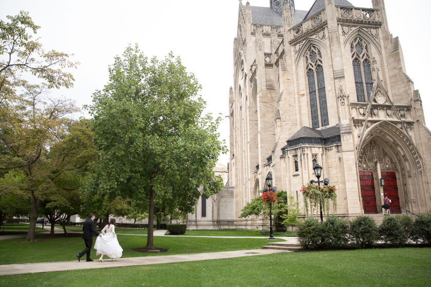 Bride and groom walking toward Heinz Chapel