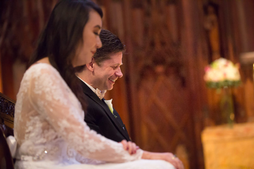 Groom laughing during his wedding ceremony at Heinz Chapel