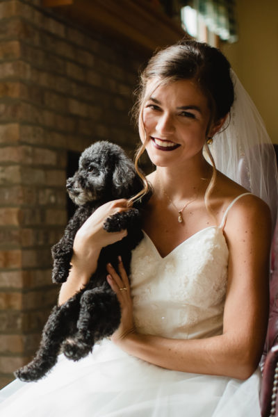 Bride with her adorable little black dog