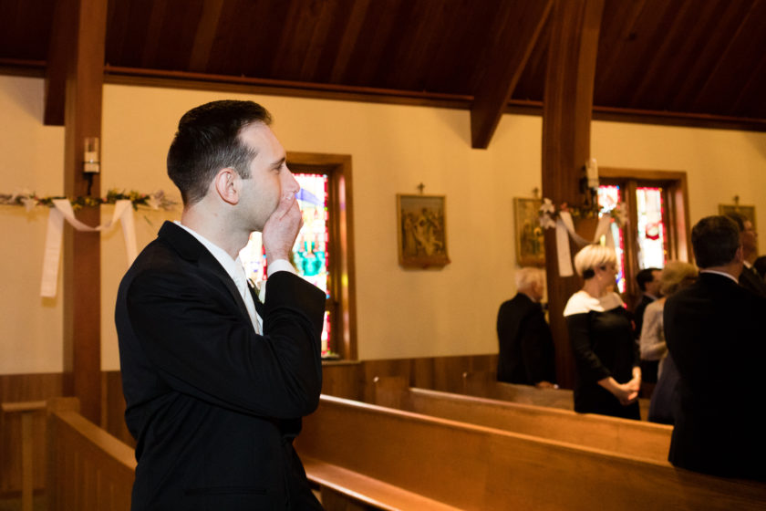 Groom excited for bride walking down the aisle