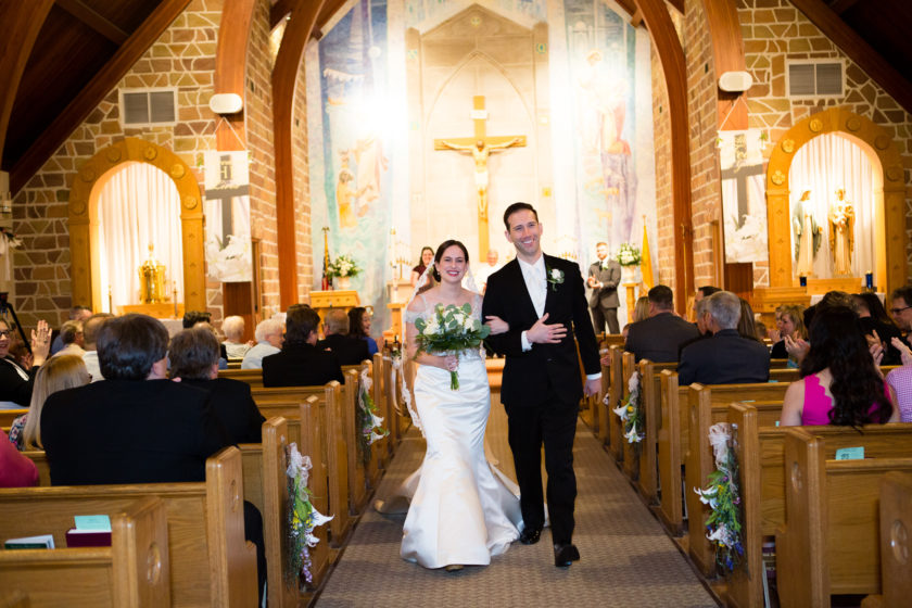 Bride and groom walking out of church