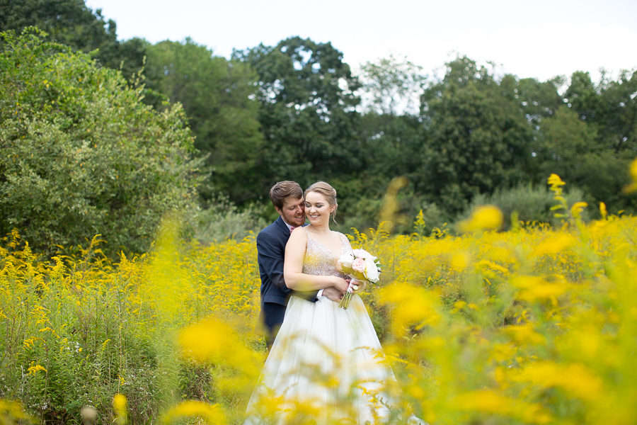 Bride and Groom in a field of yellow wildflowers