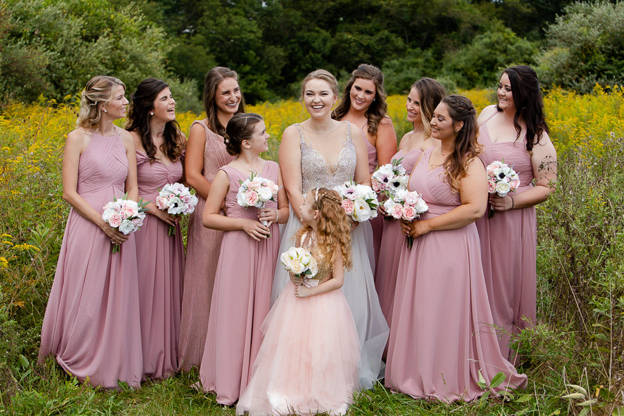 Bride and bridesmaids in a field of yellow wildflowers