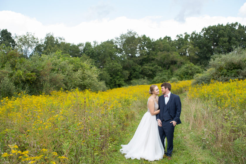 Bride and Groom in a field of yellow wildflowers