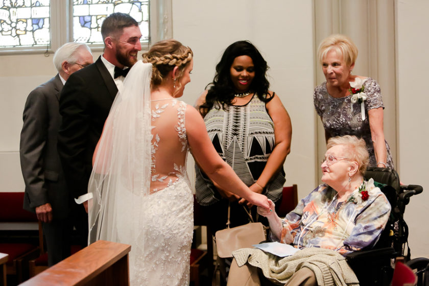 Bride and groom greet grandmother after wedding